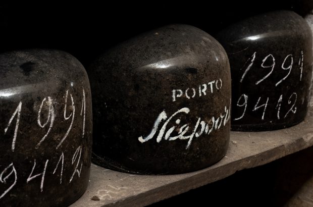 Glass demijohns on a shelf in a cellar